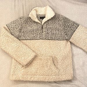 Gray and cream colored turtleneck sweater.